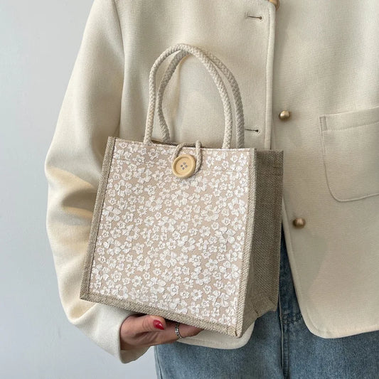 A woman carrying a linen bag goes to work carrying a bento bag with a small satchel